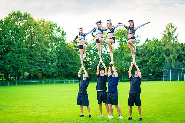 cheerleaders practicing on playing field