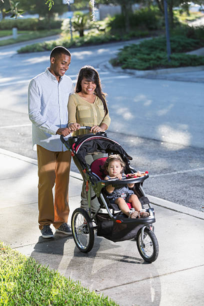 istock Young family with baby in stroller 465400599