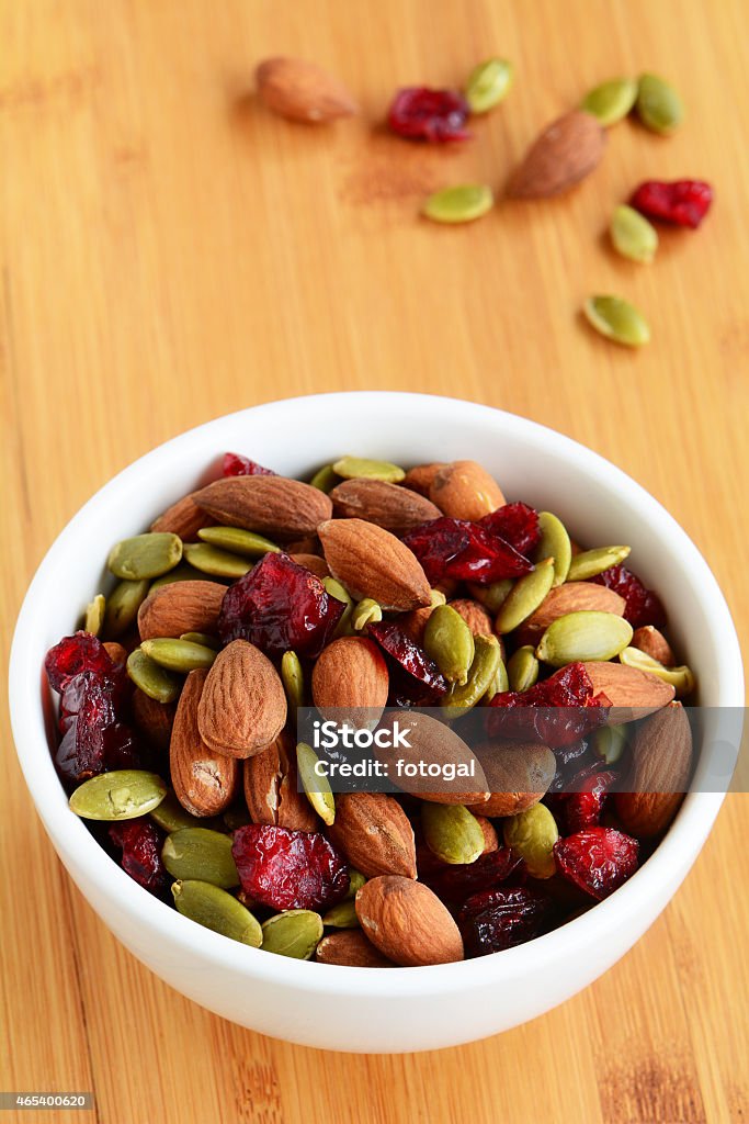 Organic trail mix Organic trail mix of roasted almonds, raw pumpkin seeds (pepitas) and dried cranberries for a healthy snack 2015 Stock Photo