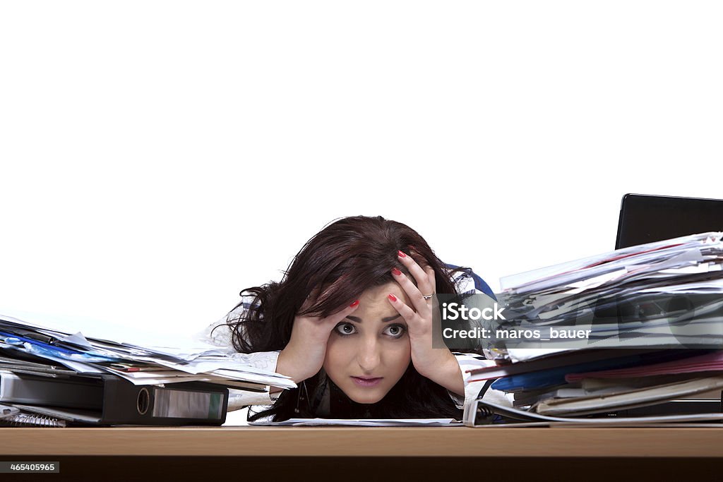 Young female office worker Young female office worker helplessly looking at the pile of papers with place for text Document Stock Photo
