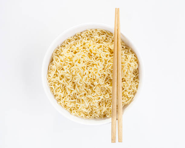 istock Egg noodle in a white bowl with chopsticks isolated 465410752