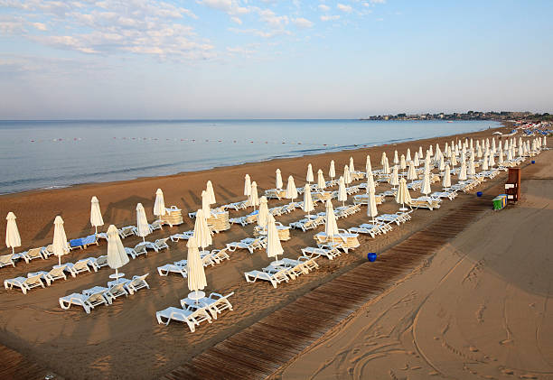 istock Sun beds and umbrellas on the beach 465411651