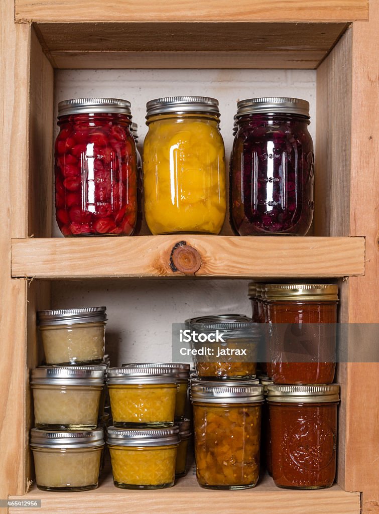 Storage shelves with canned food Storage shelves in pantry with homemade canned preserved fruits and vegetables Shelf Stock Photo