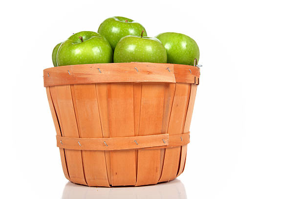 Close-up of fresh red apples in the basket on dark background