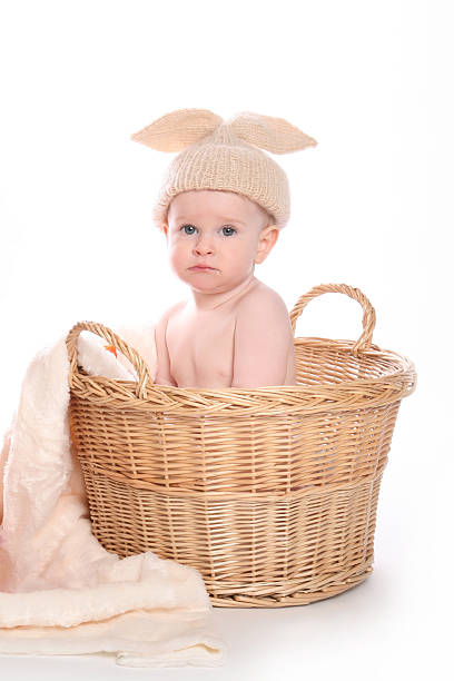 istock Cute rabbit boy sitting in basket sad 465416033