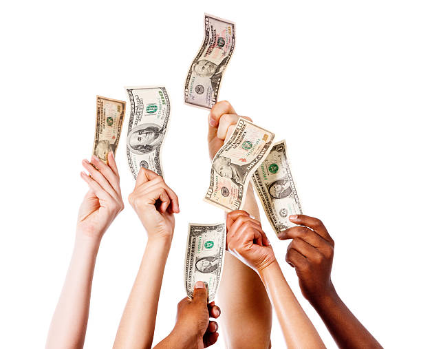 istock Take my money! Many hands waving US banknotes in air 465417633