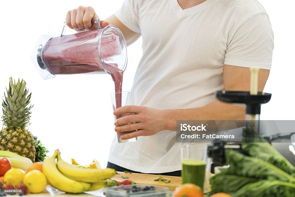 Smoothie A man making healthy smoothie with fruits and vegetables. Men Stock Photo