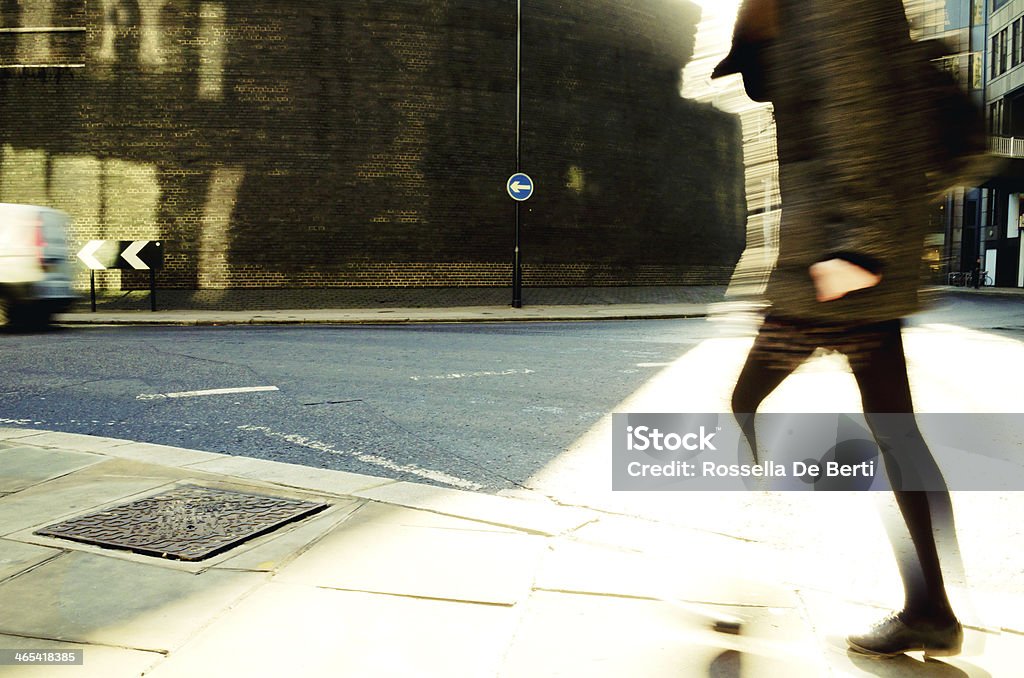 Urban Scene, Commuting. Urban scene in London. Blurred motion. A pedestrian walking on the street. Brick wall on the background. Copy space. England Stock Photo