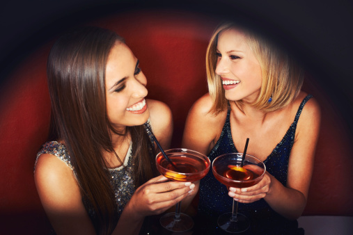 Two gorgeous young woman enjoying cocktails
