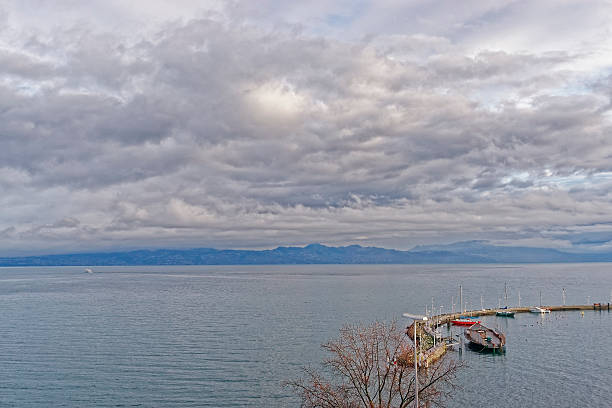 Lake view over Lac Leman in  Evian-les-Bains Lake view over Lac Leman in  Evian-les-Bains in France in the New year in winter evian les bains stock pictures, royalty-free photos & images