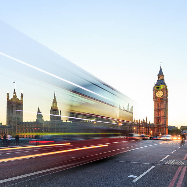 istock London night - Big Ben with blurred double-decker bus 465420511