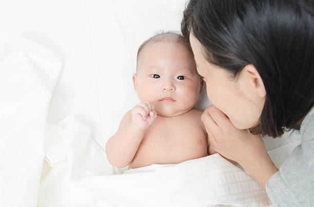 istock young mom kissing her baby 465421163