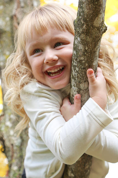 istock Adorable Little Girl Climbing a Tree 465424477