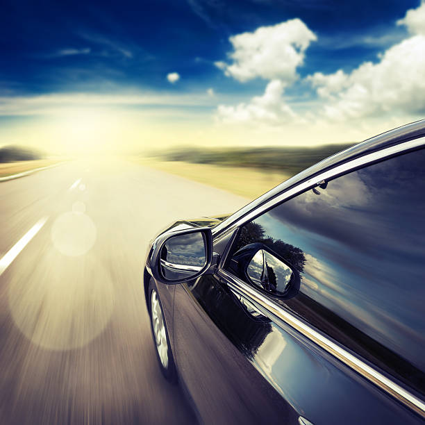 istock A car driving down the road towards the sunset  465424806