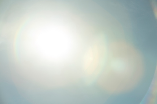 This picture is part of a design elements series. It is a picture of a lens flair. It can be overlaid onto other images to create a retro effect. In this image the the sun is in the centre left with the flair trailing off to the right.   
