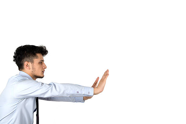 istock Young businessman pushing invisible obstacles 465427203