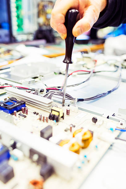 istock TV repair man working on big plasma televsion 465427775