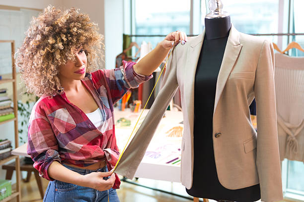 istock Young fashion designer measuring a blazer 465429569