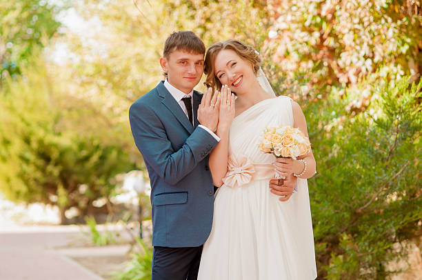 istock The bride and groom in summer park 465430802