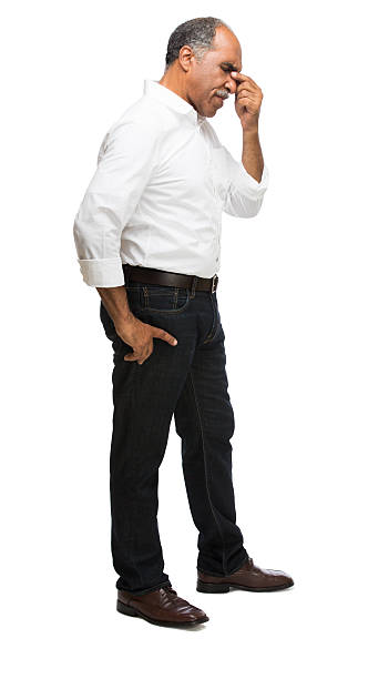 Worried latin male A worried latin man with his hand on his face. Isolated on a white background. worried man standing stock pictures, royalty-free photos & images