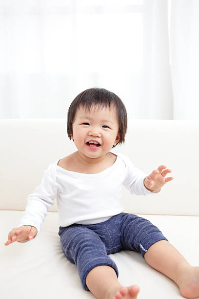 istock cute baby sitting on sofa 465432167