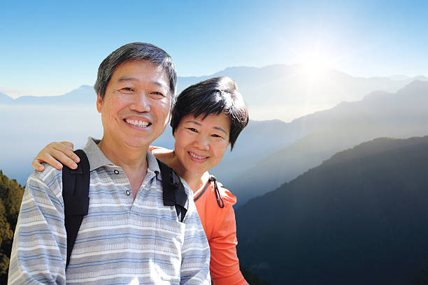 istock senior couple hiking with mountain 465432527