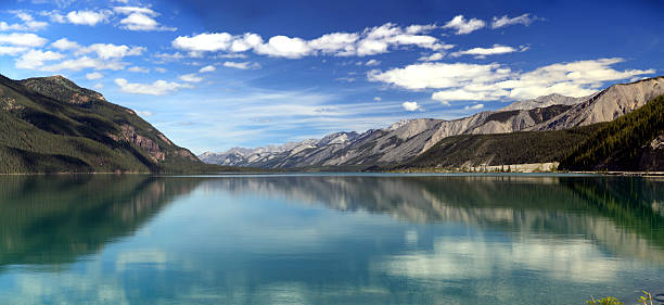 Reflections on Muncho Lake in northern British Columbia, Canada. stock photo
