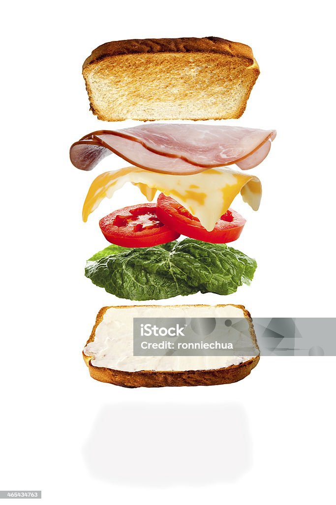 Putting Together a Cheese and Ham Sandwich All the ingredients of a melted cheese and ham sandwich falling into place Sandwich Stock Photo