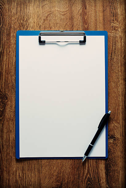 istock Blank clipboard and pen on a wooden desk 465448834