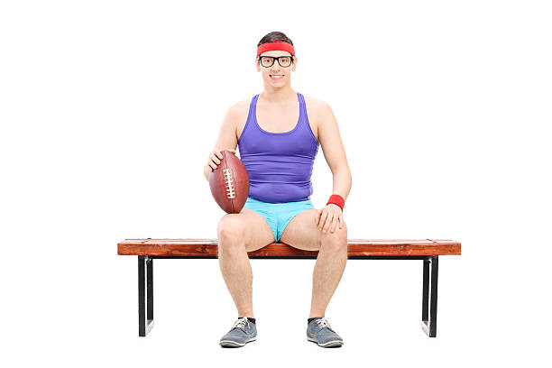 istock Male football player sitting on a bench 465449182