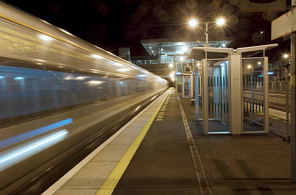 istock Empty  Station Platform late at Night as speeding train passes 465450017