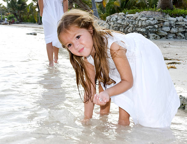 istock Little girl playing at the beach 465451009