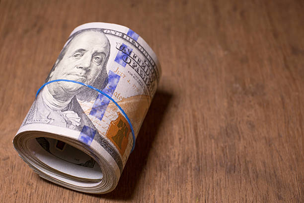 istock Roll of One Hundred Dollar Bills 465451618