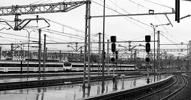 Rail yard, tracks and trains at Chamartín train station in Madrid, Spain. Black and white.
