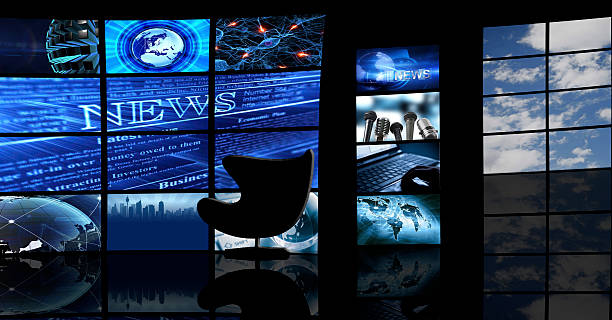 Multiple TV screens display news in a dark studio