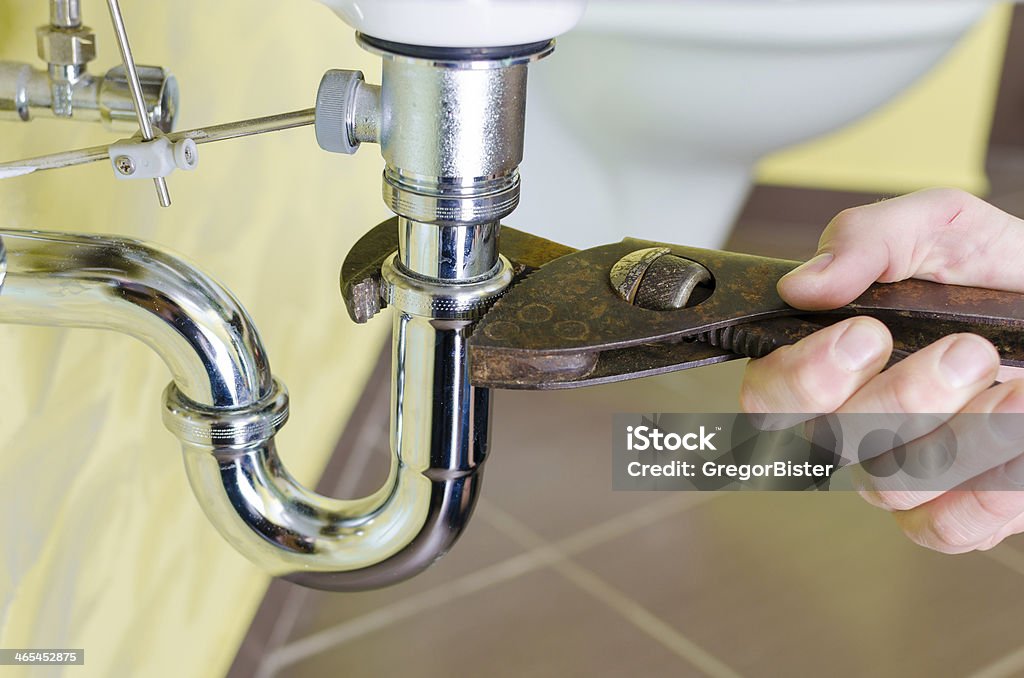 Plumber Photo of plumber repairing drain.   Accidents and Disasters Stock Photo
