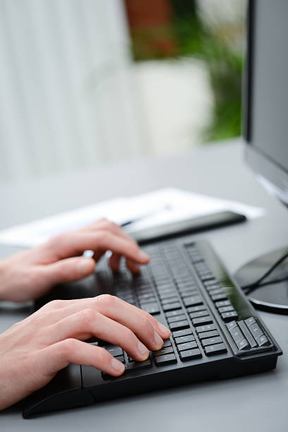 istock close up of hands detail typing on desktop computer keyboard 465453368
