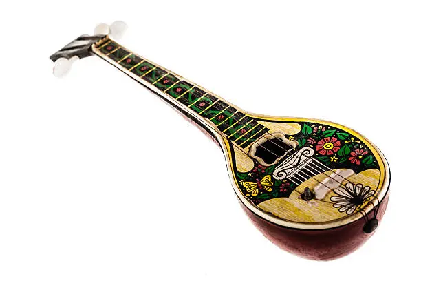 a dirty toy bouzouki isolated over a white background