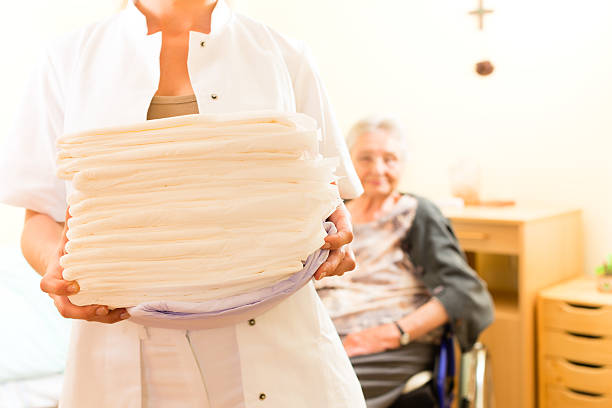 Young nurse and female senior in nursing home stock photo