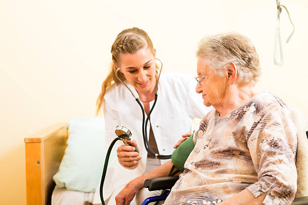 istock Young female nurse checking elderly woman's blood pressure 465456629