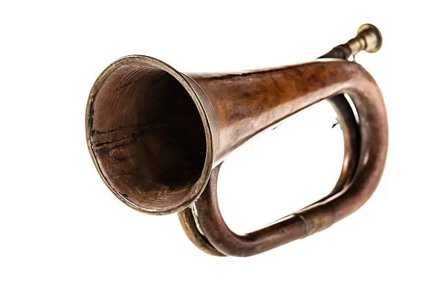 an old and rusty bugle isolated over a white background