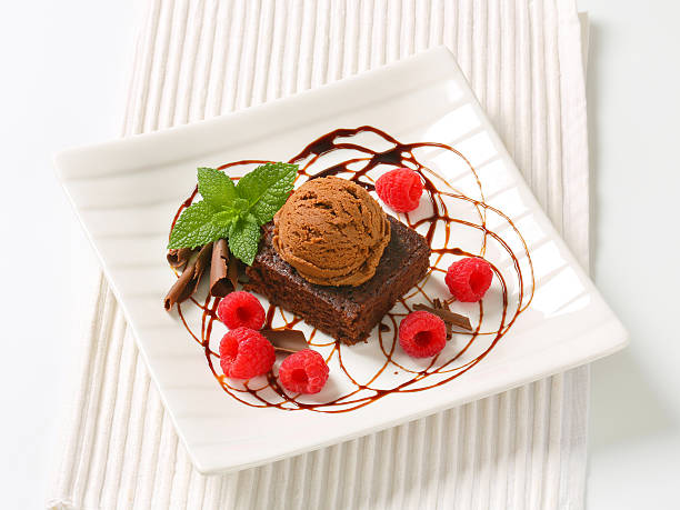 istock Chocolate Brownie with ice cream and raspberries 465457765