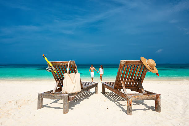 istock Couple in white running on a beach at Maldives 465458488
