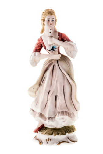 German statuette depicting a traditional dressed woman Isolated on white