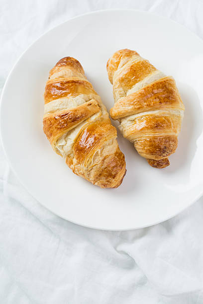 istock delicious breakfast with croissants in bed 465462340