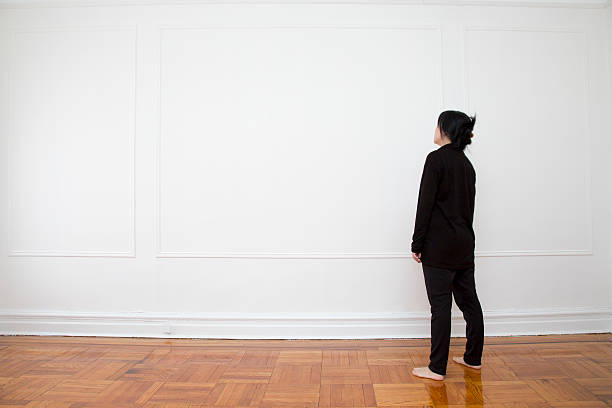 istock Woman Looking at Blank Wall 465462416