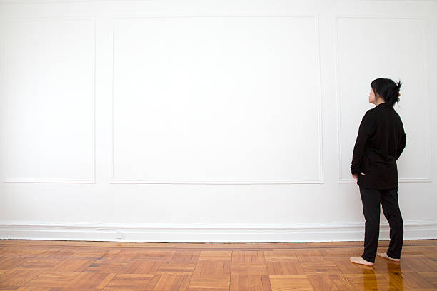 istock Woman Looking at Blank Wall 465462418