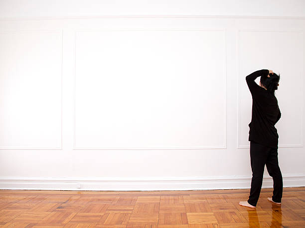 istock Woman Looking at Blank Wall 465462420