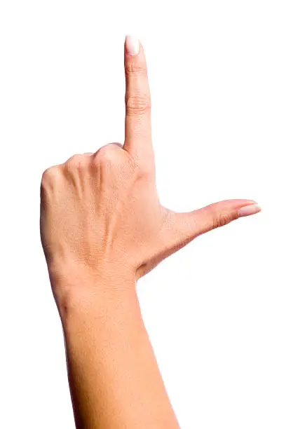 Photo isolated in white of a hand of a caucasian woman, touching with the index finger or doing the "L" symbol
