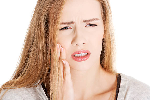 istock Woman holding her face due to toothache 465464685